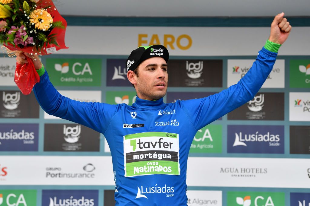 FARO PORTUGAL FEBRUARY 18 Joo Carlos Arajo Matias of Portugal and Team TavferMortguaOvos Matinados celebrates winning the blue mountain jersey on the podium ceremony after the 48th Volta Ao Algarve 2022 Stage 3 a 2114km stage from Almodvar to Faro VAlgarve2022 on February 18 2022 in Faro Portugal Photo by Luc ClaessenGetty Images