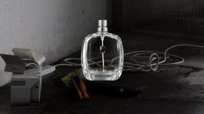12 Things perfume bottle on background of decay and destruction