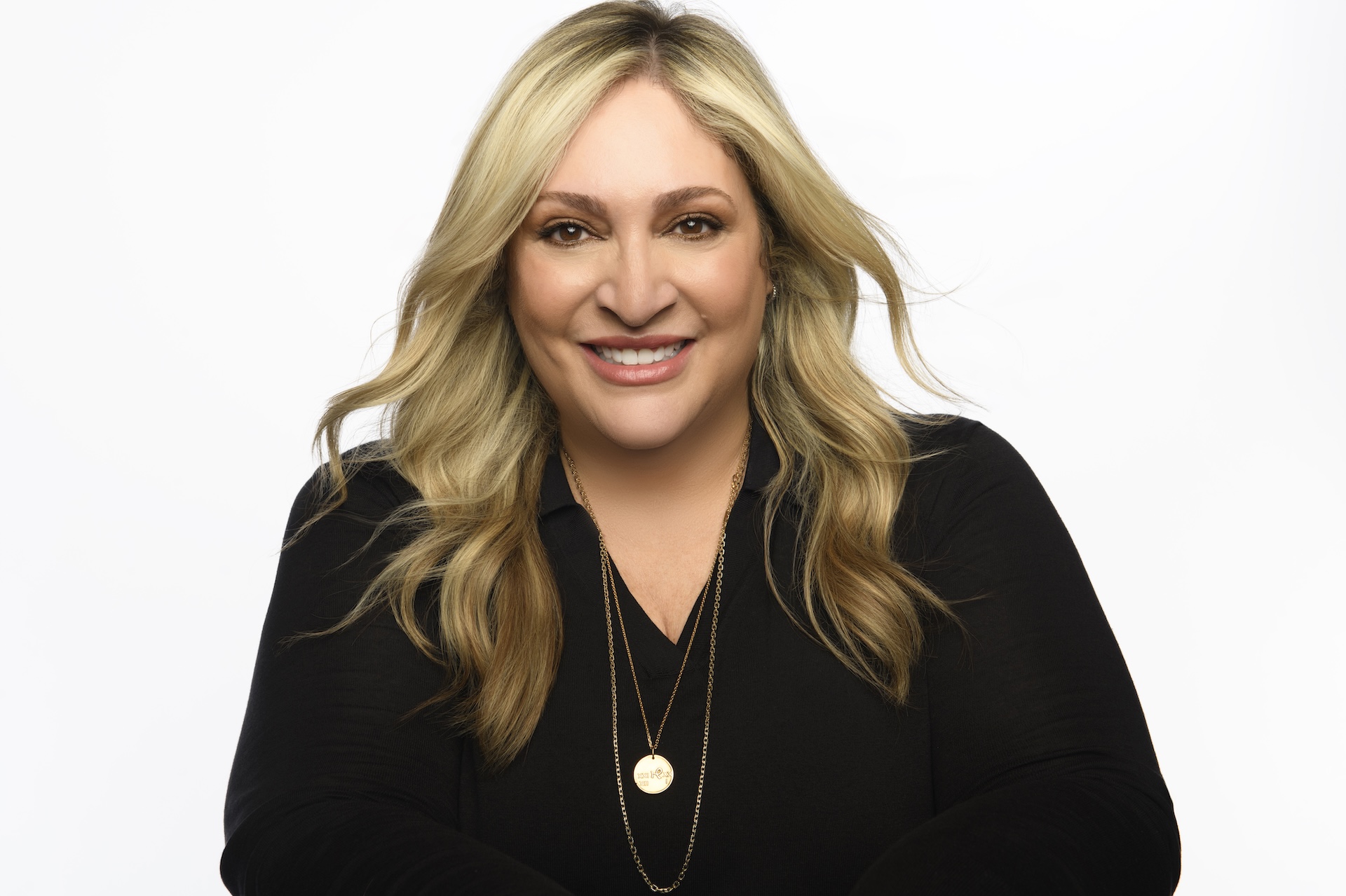 a white woman with blonde hair in a black top