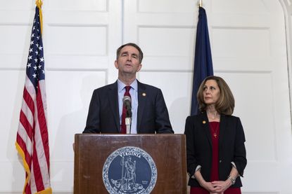 Virginia Governor Ralph Northam (D), flanked by his wife Pam, speaks with reporters at a press conference at the Governor's mansion on February 2, 2019 in Richmond, Virginia. 