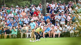 Rory McIlroy of Northern Ireland makes a birdie putt on the 10th hole green as patrons watch during the first round of the 2023 Masters Tournament at Augusta National Golf Club on April 6, 2023