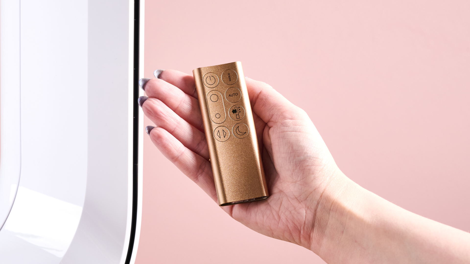 A woman's hand is holding the remote.