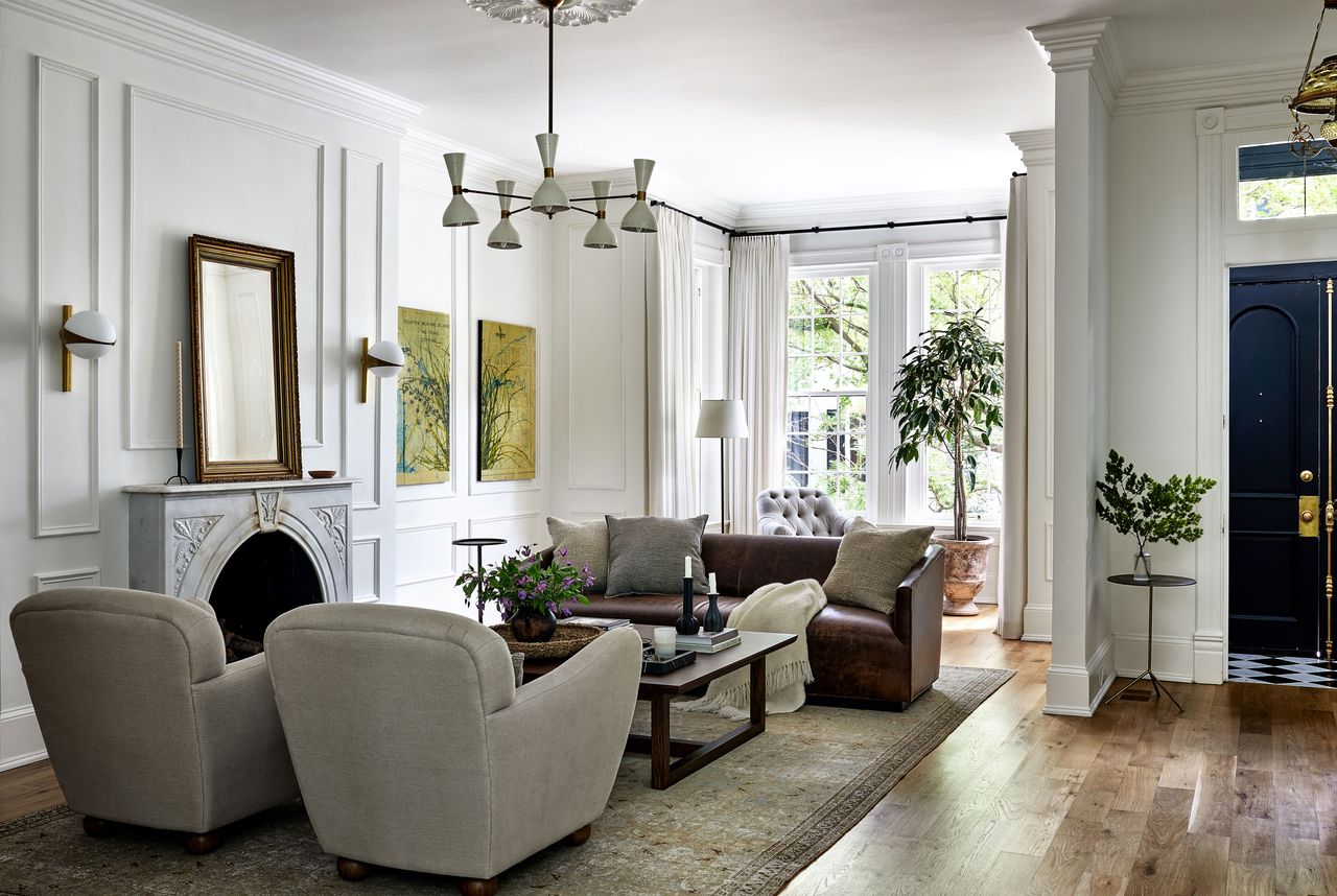 A living room in muted tones, and a chandelier 