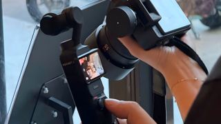 DJI Osmo Pocket 3 being held in front of another camera