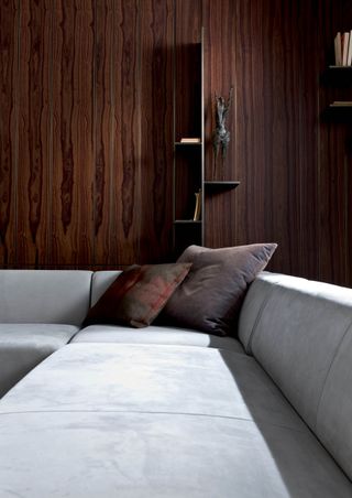 Dark vertical wood wall design with grey sofa and cushion