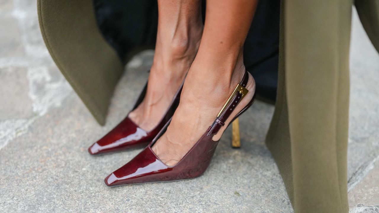 Feet in a pair of brown slingback patent shoes, with soft skin as though she has used one of the best foot scrubs