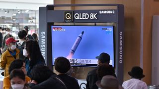 People in a railway station in Seoul, South Korea watch a news broadcast with file footage of a North Korean missile test on May 7, 2022. North Korea launched a submarine-based ballistic missile test earlier that day.