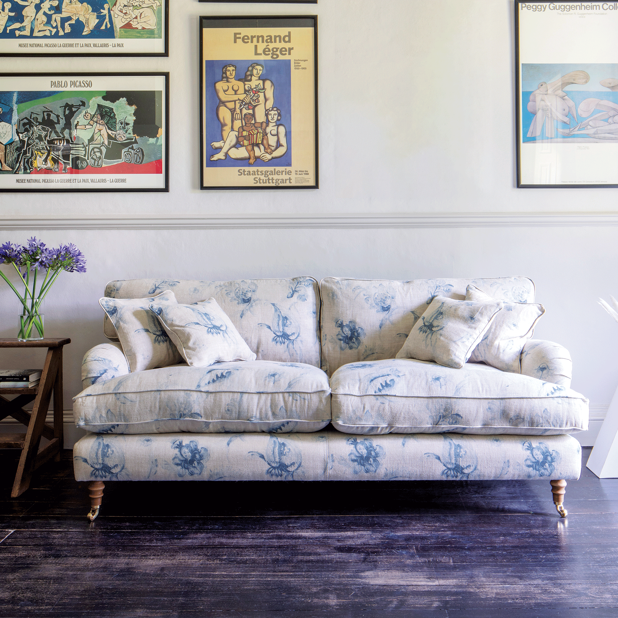White and blue patterned sofa in a white hallway