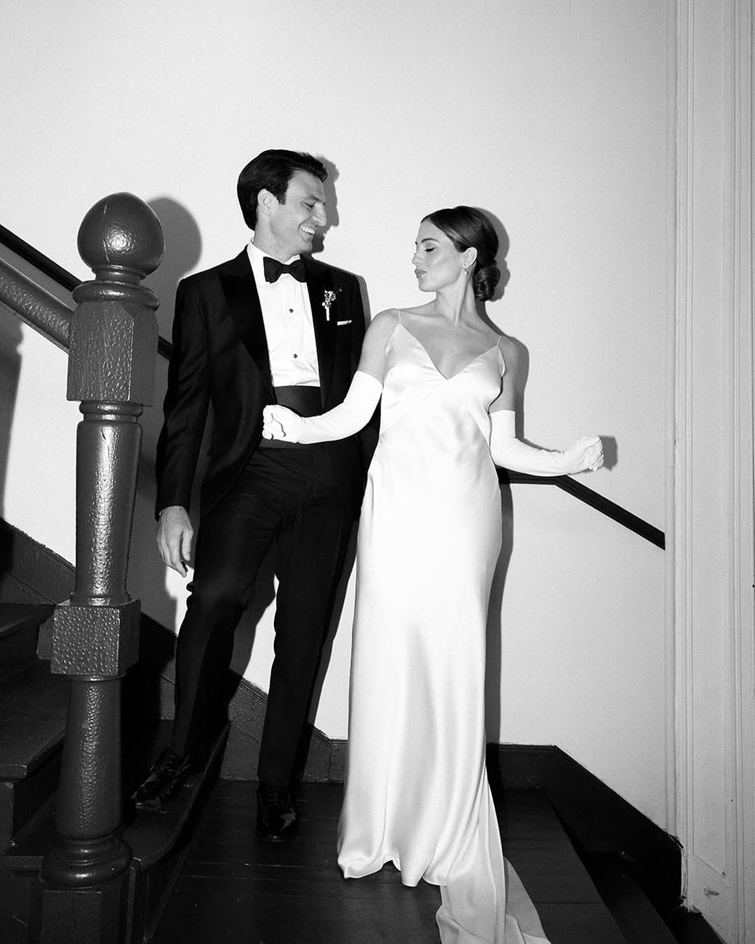 A direct flash black-and-white photo of a couple on a staircase