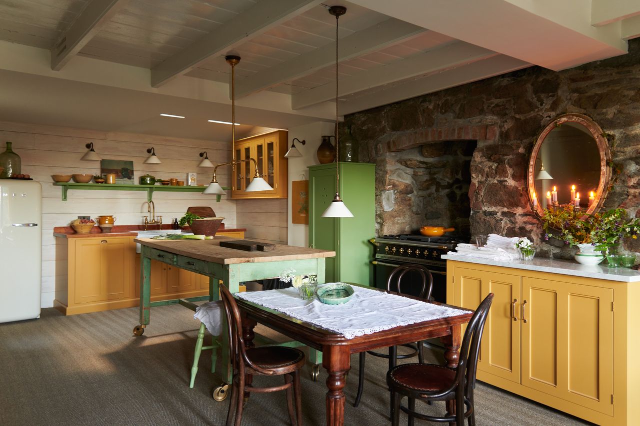 classic English kitchen with cream wooden wall and ceeling, stone wall, with themes of yellow and green throughout the room