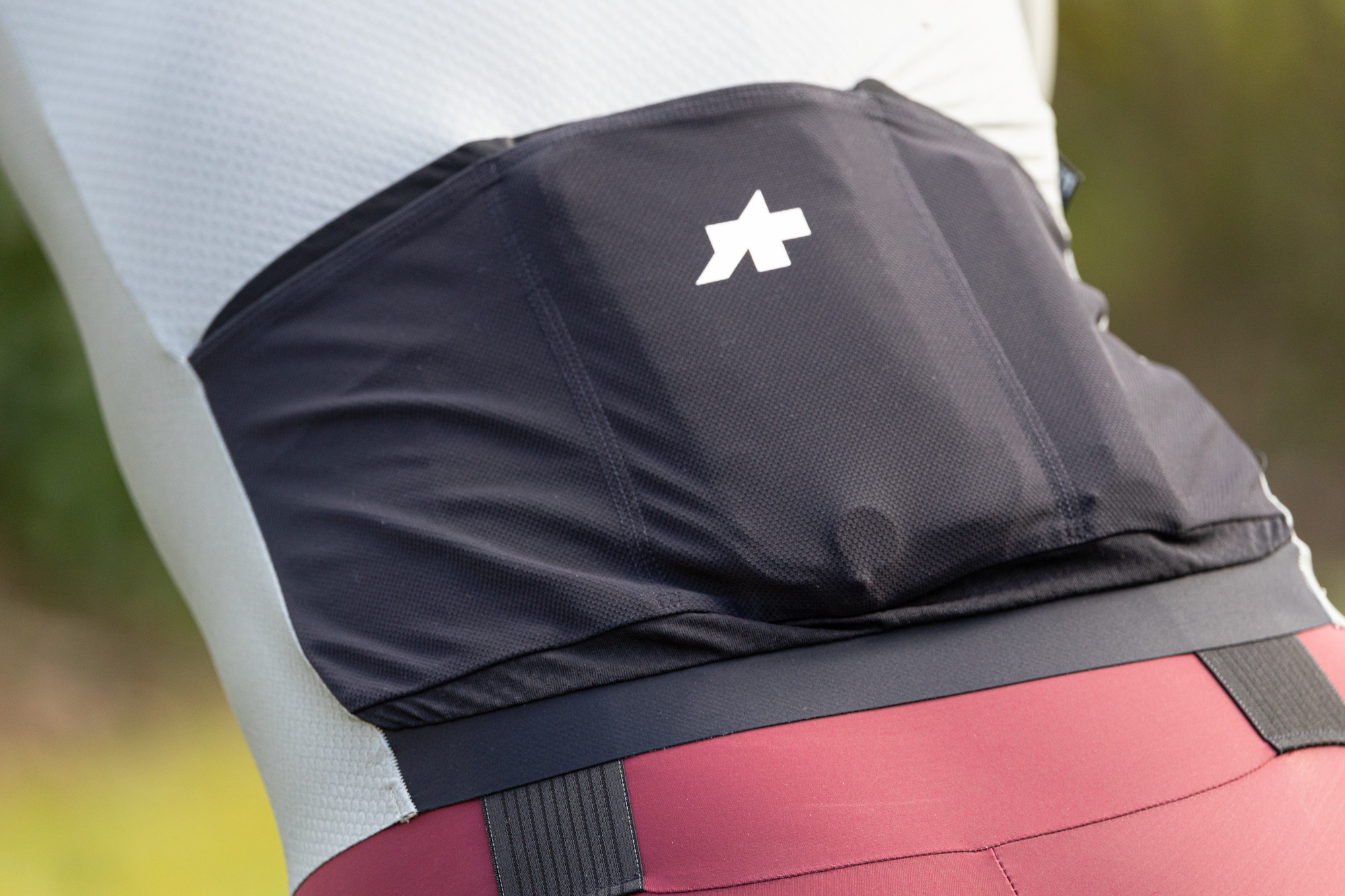 close up of the black rear pockets on a pale green cycling jersey.