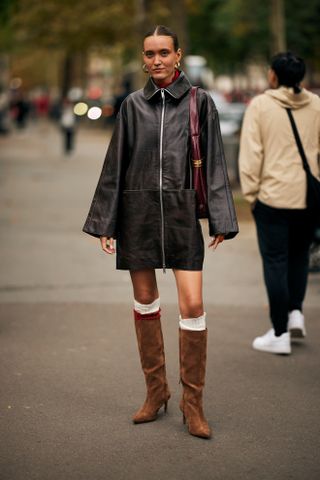 woman wearing suede boots at Paris Fashion Week