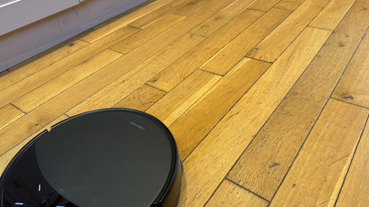 Roborock Saros 10R robot vacuum and mop after completing vacuuming test on hard floor