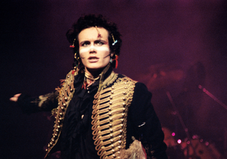1980s Fashion: Adam Ant performing wearing white face paint whilst wearing a military jacket