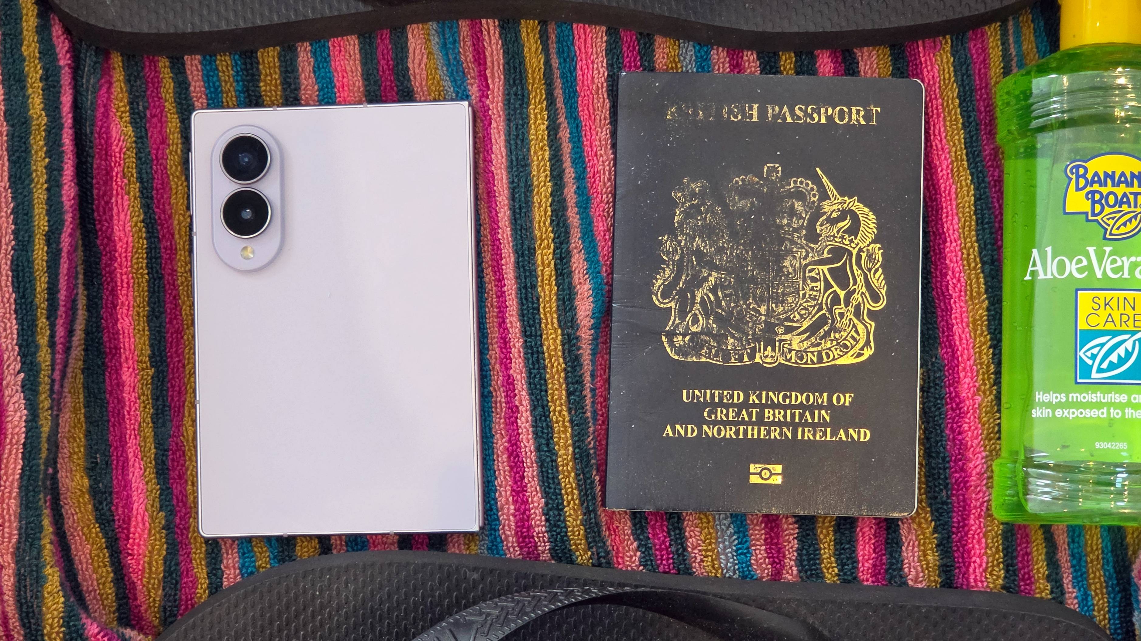 The Samsung Galaxy Z Fold 8 n a suitcase next to a British passport.
