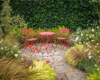 red bistro set on a small round paved patio