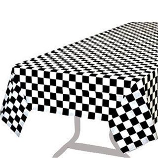 A black and white checkerboard tablecloth on a table with gray metal legs