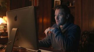 Joel Edgerton sitting at a computer in Dark Matter