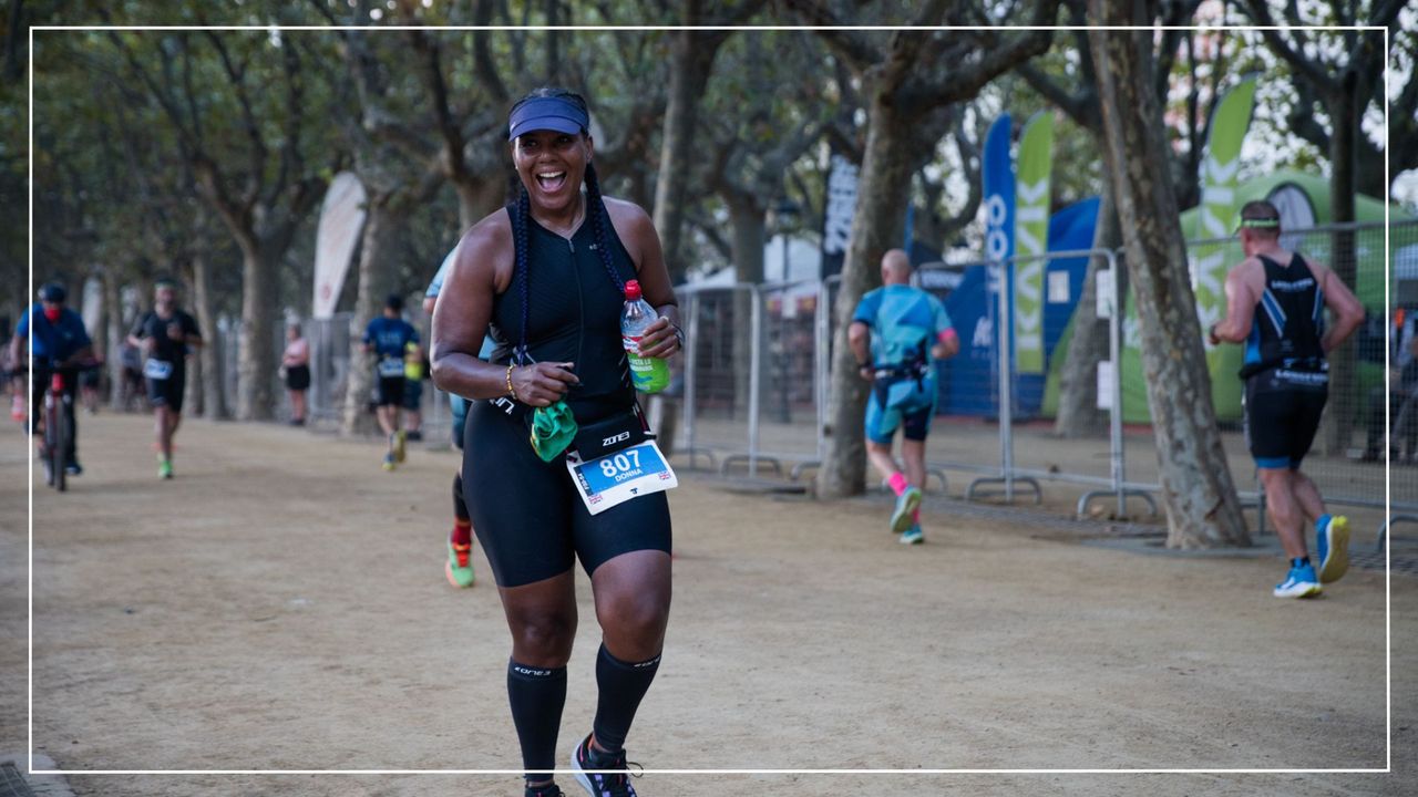 Donna McConnell running a race as part of her triathlon training, laughing and smiling looking at the camera