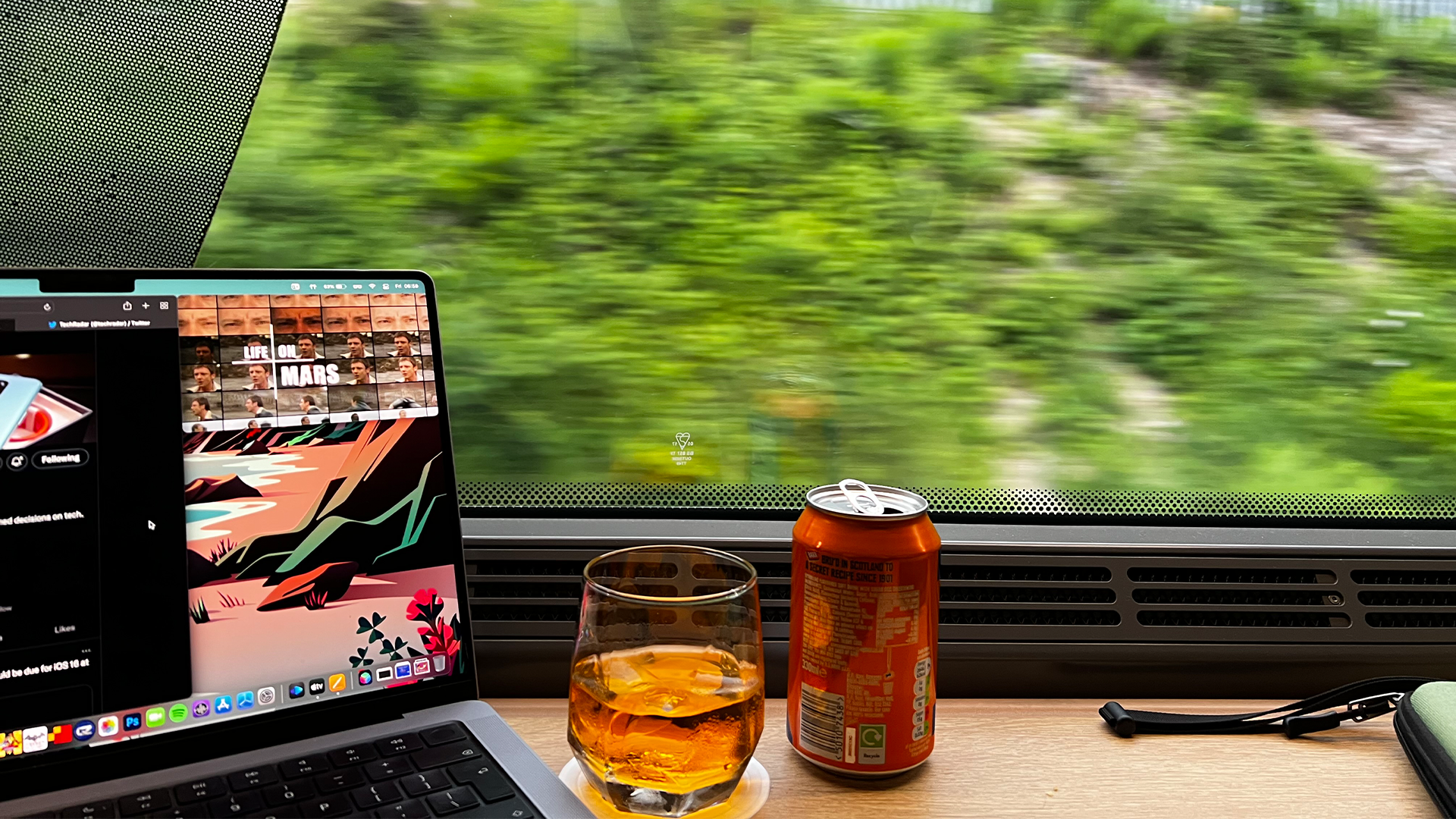 with a Mac on the Caledonian Sleeper in the lounge area with an Irn Bru