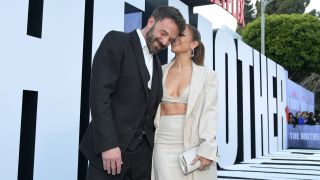 Ben Affleck smiling and Jennifer Lopez whispering something to him at The Mother premiere.
