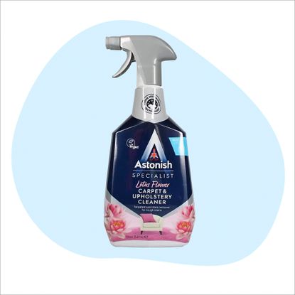 Astonish upholstery cleaner bottle on a blue and white background