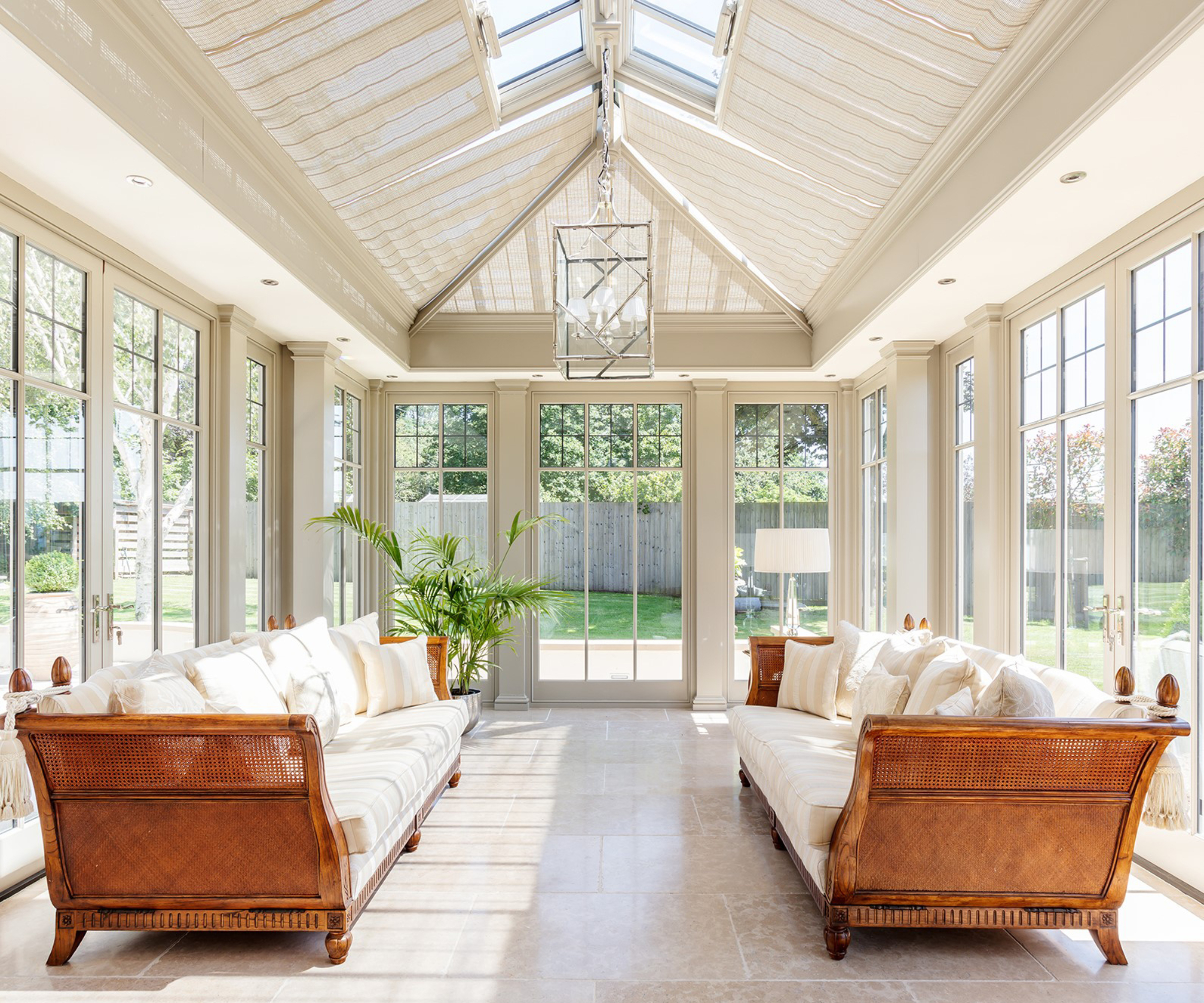 interior of cream orangery sitting room with blinds on rooflight