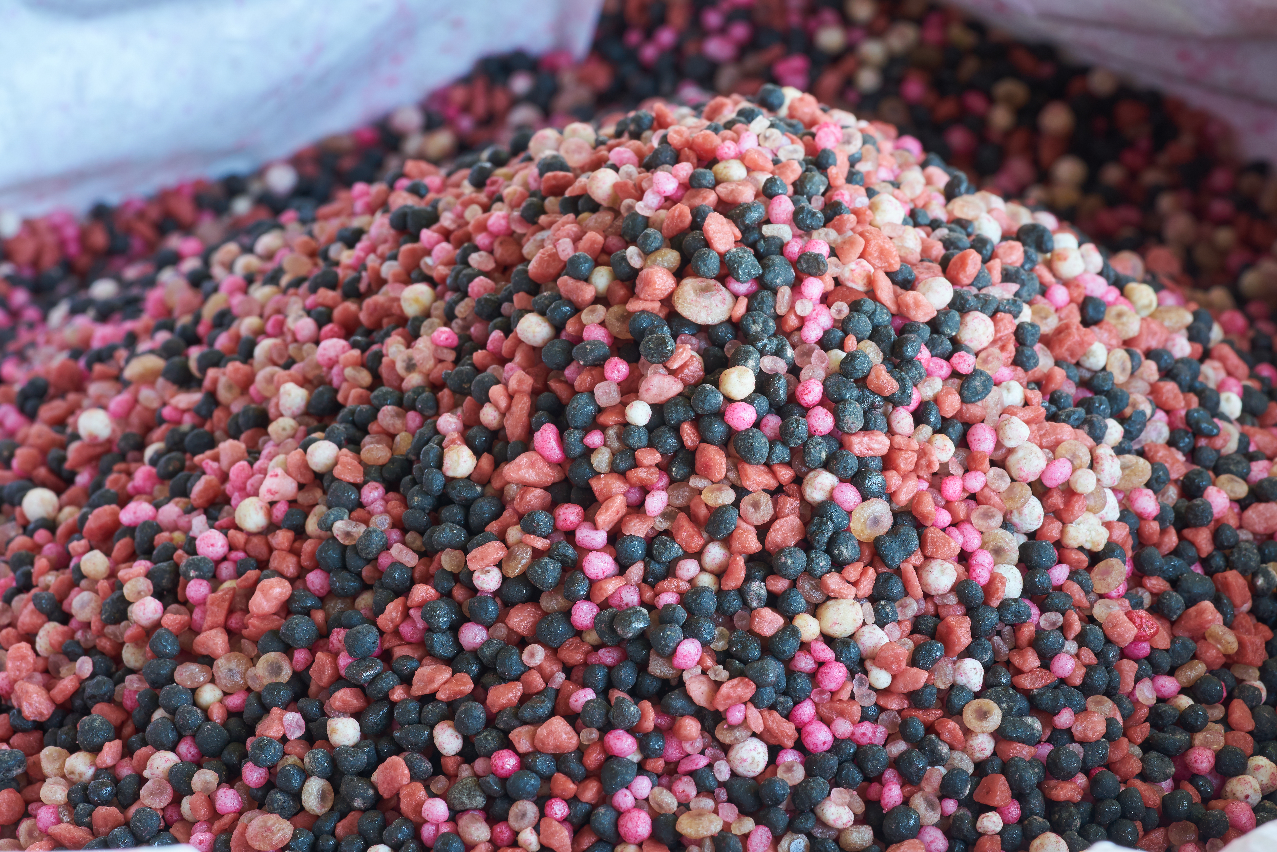 Pink, white and black granular fertilizer in a pile