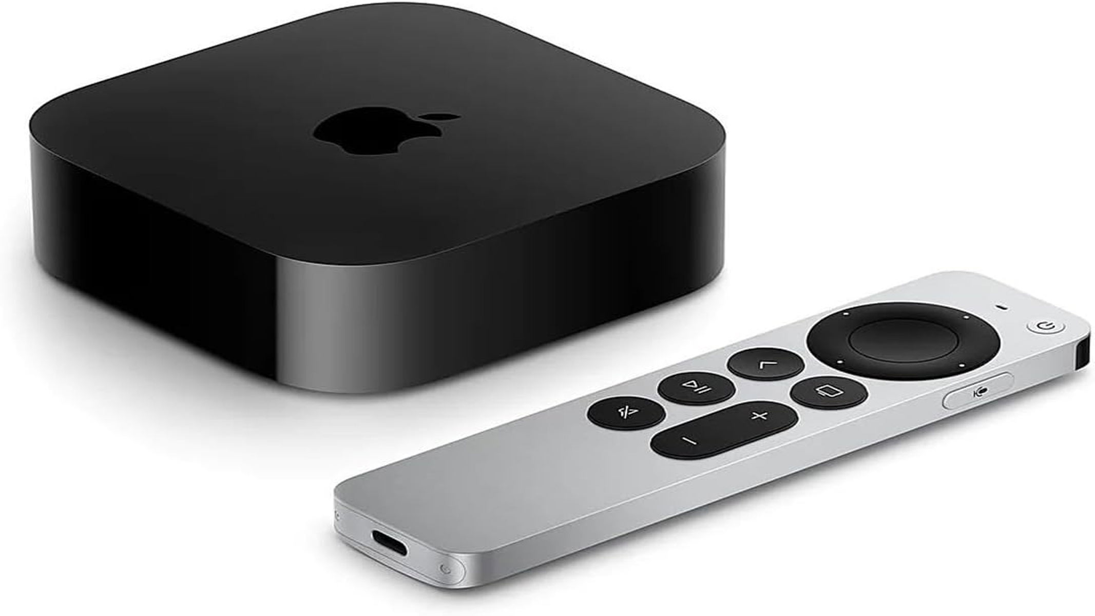 A silver metallic remote controller is laying flat next to a smooth, well-rounded box with an apple for a logo in the center, all on a white background.