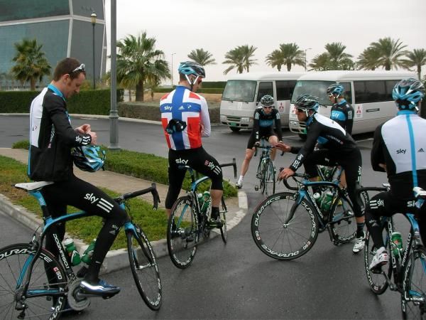 Brad Wiggins adjusts his helmet as Kurt-Asle Arvesen and Russell Downing chat before the team's training ride