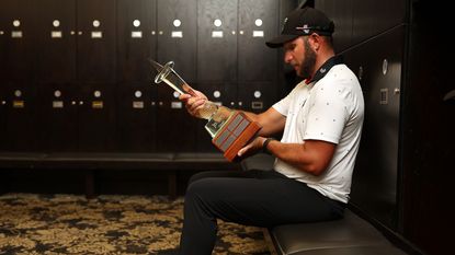 Dean Burmester looks at his trophy in the locker rooms at Houghton Golf Club in Johannesburg, South Africa