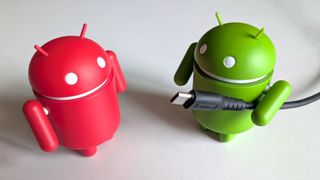 Android figurine holding a USB-C cable