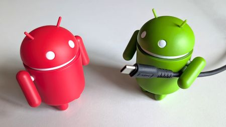 Android figurine holding a USB-C cable