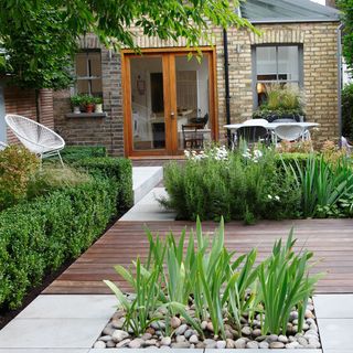 outside sitting area with wooden flooring and plants