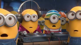 A crowd of Minions looking intently towards the camera in Minions: The Rise of Gru.