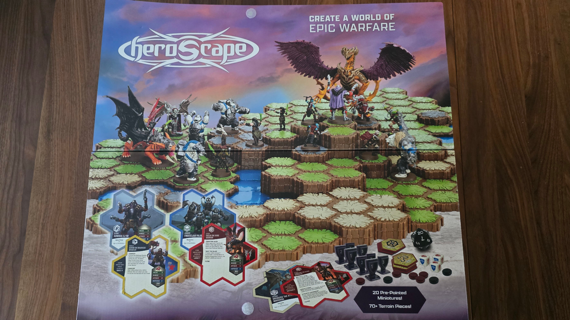 A view of tiles, models, components, and dice from the Heroscape franchise, laid out on a wooden surface