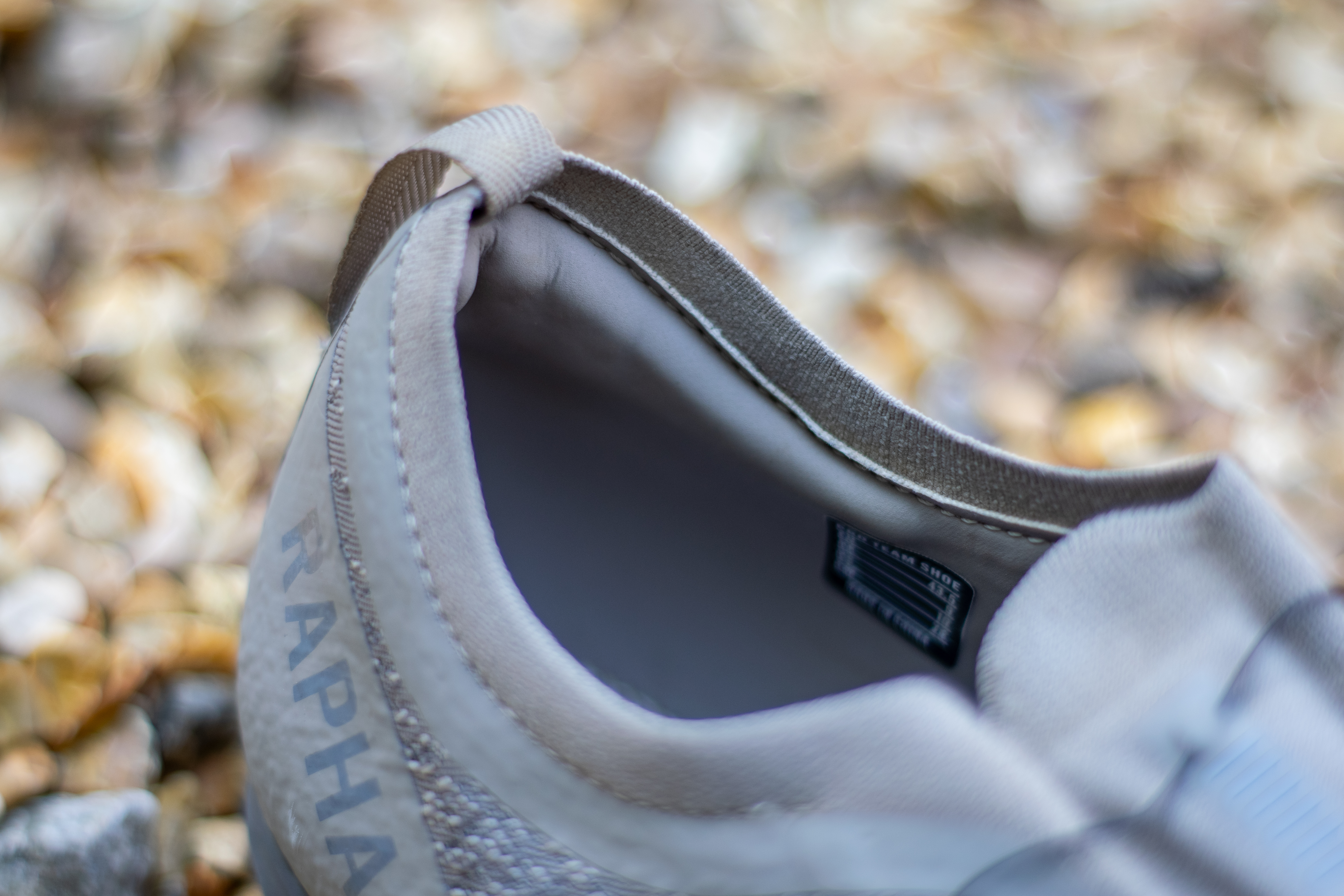 A pair of Rapha Pro Team Gravel shoes on some gravel