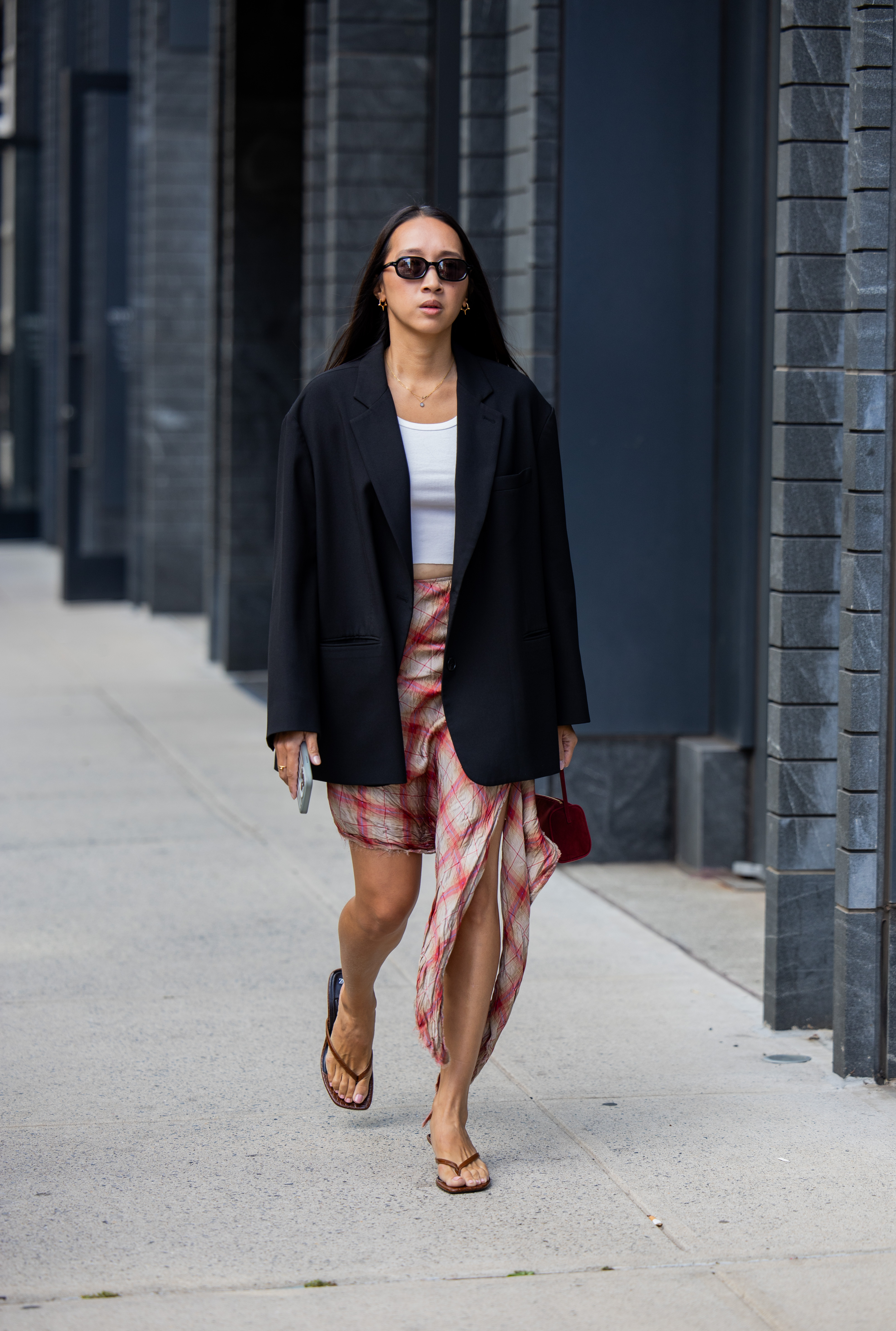Influencer wearing a skirt, flip flops, and a blazer