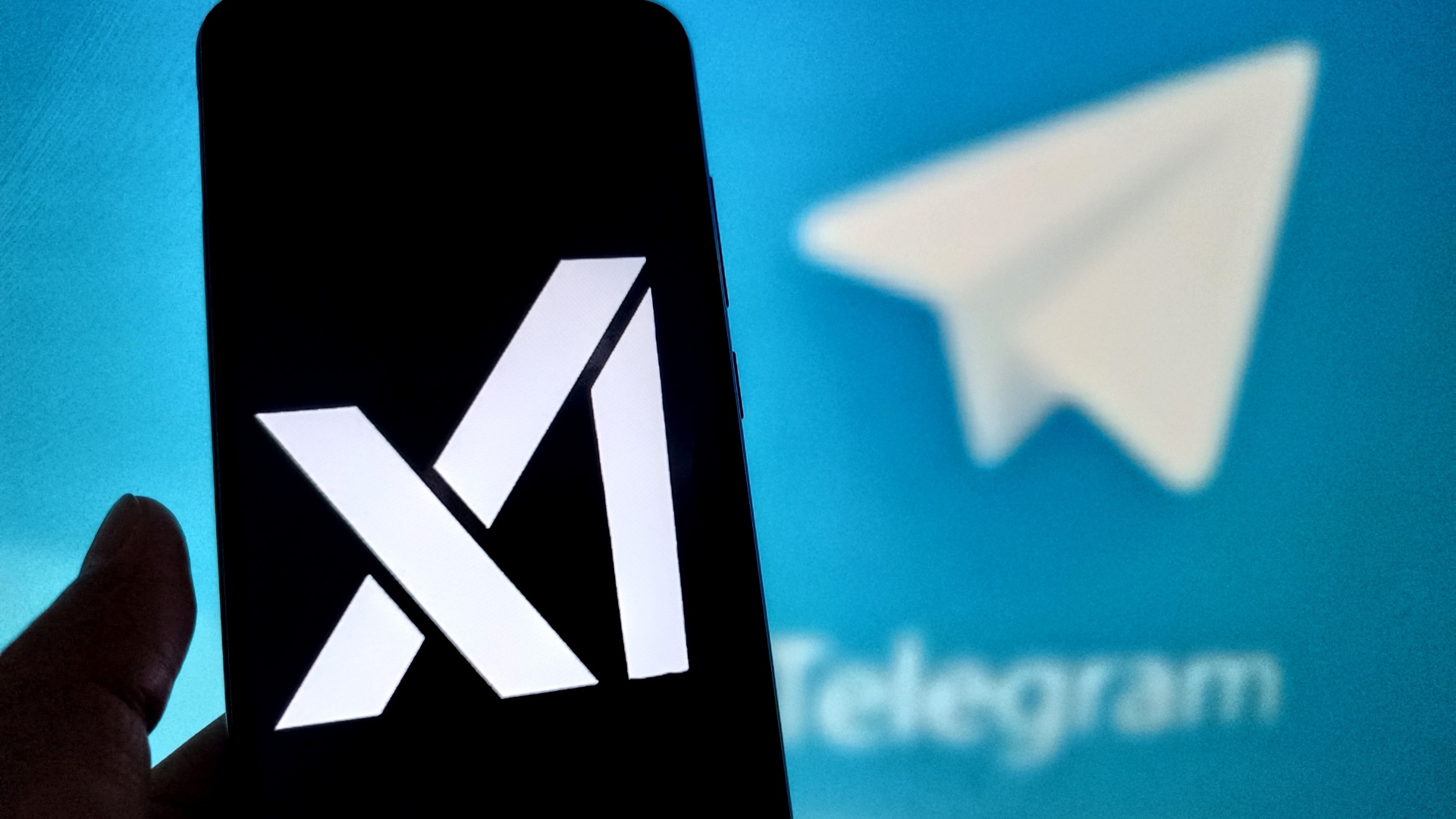 xAI logo is displayed on a smartphone screen with a Telegram logo in the background.
