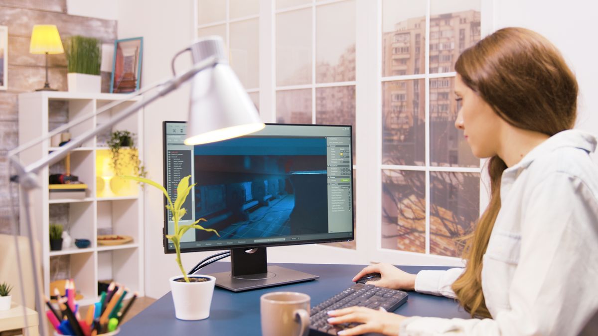 A woman working from home in front of a monitor