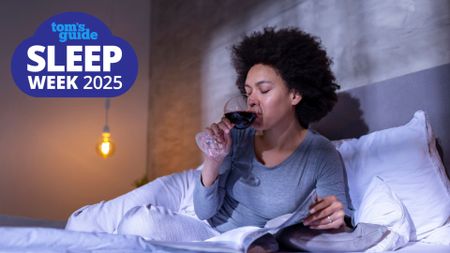 A woman lying in bed reading a book and sipping a glass of red wine, with the Tom's Guide Sleep Week 2025 logo in the top left corner