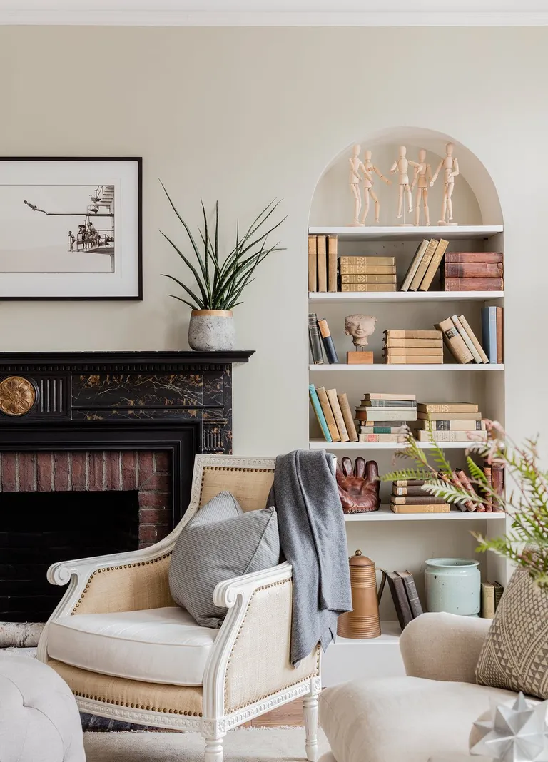 vintage books on shelves in neutral living room