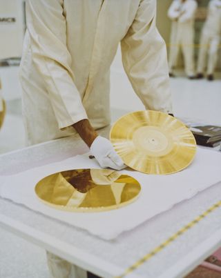 A Golden Record is prepared to be attached to NASA's Voyager spacecraft in 1977.