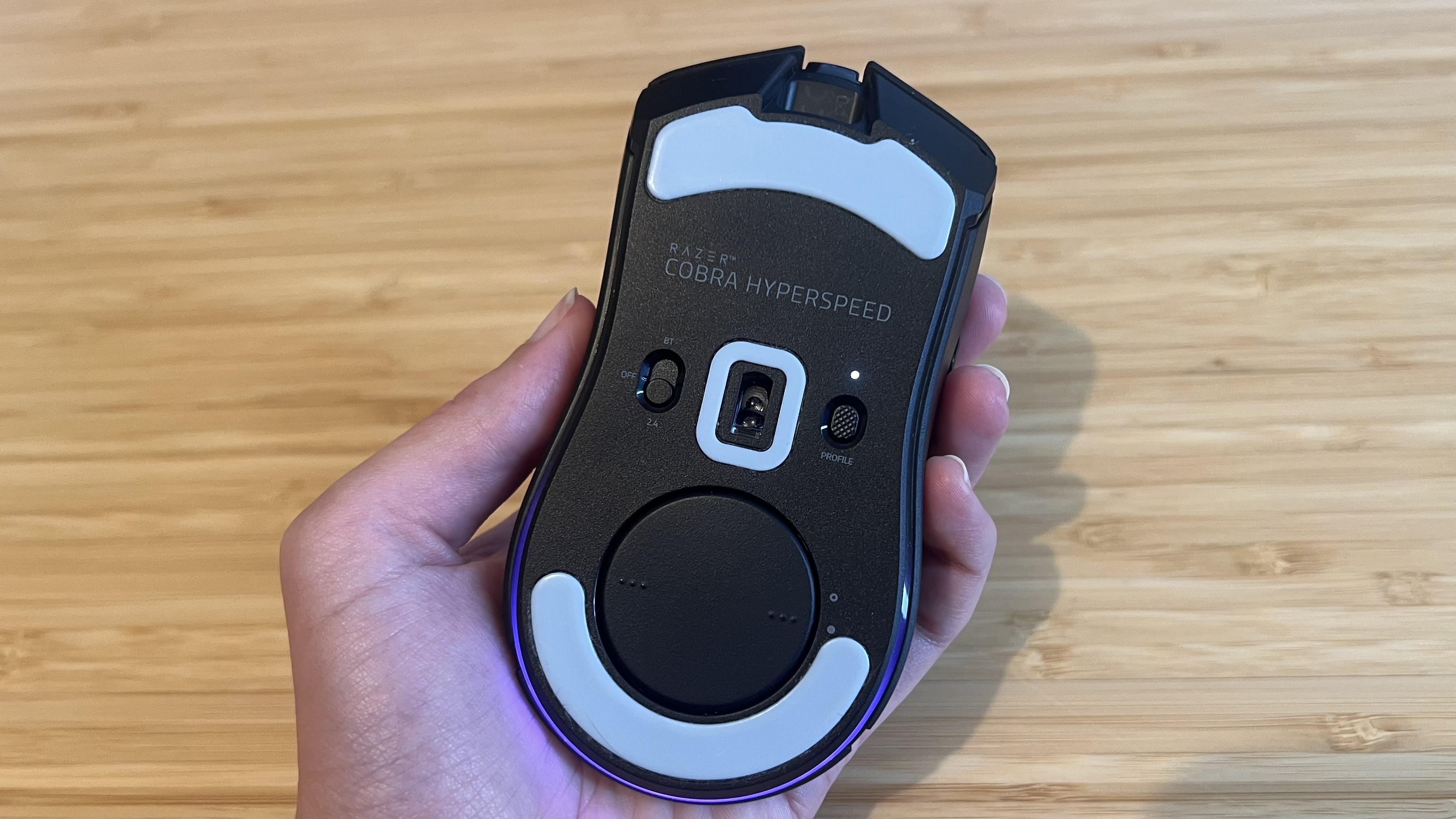 Underside of Razer Cobra Hyperspeed, showing sensor, power, and connection options