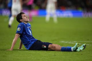 Italy's Federico Chiesa sits down on the pitch during the semi-final against Spain