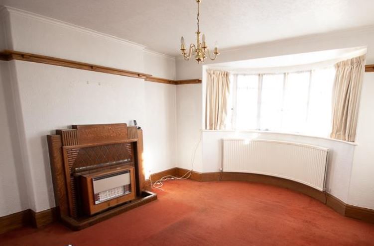 Another fireplace in a room with orange carpet