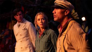 The Rock, Jack Whitehall and Emily Blunt with their arms tied around their back at night in The Jungle Cruise.