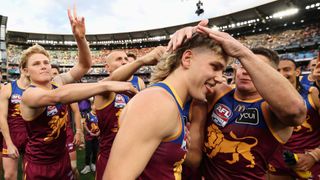 Will Ashcroft of the Brisbane Lions being congratulated by teammates after being named the Norm Smith medalist during the AFL Grand Final in September 2025