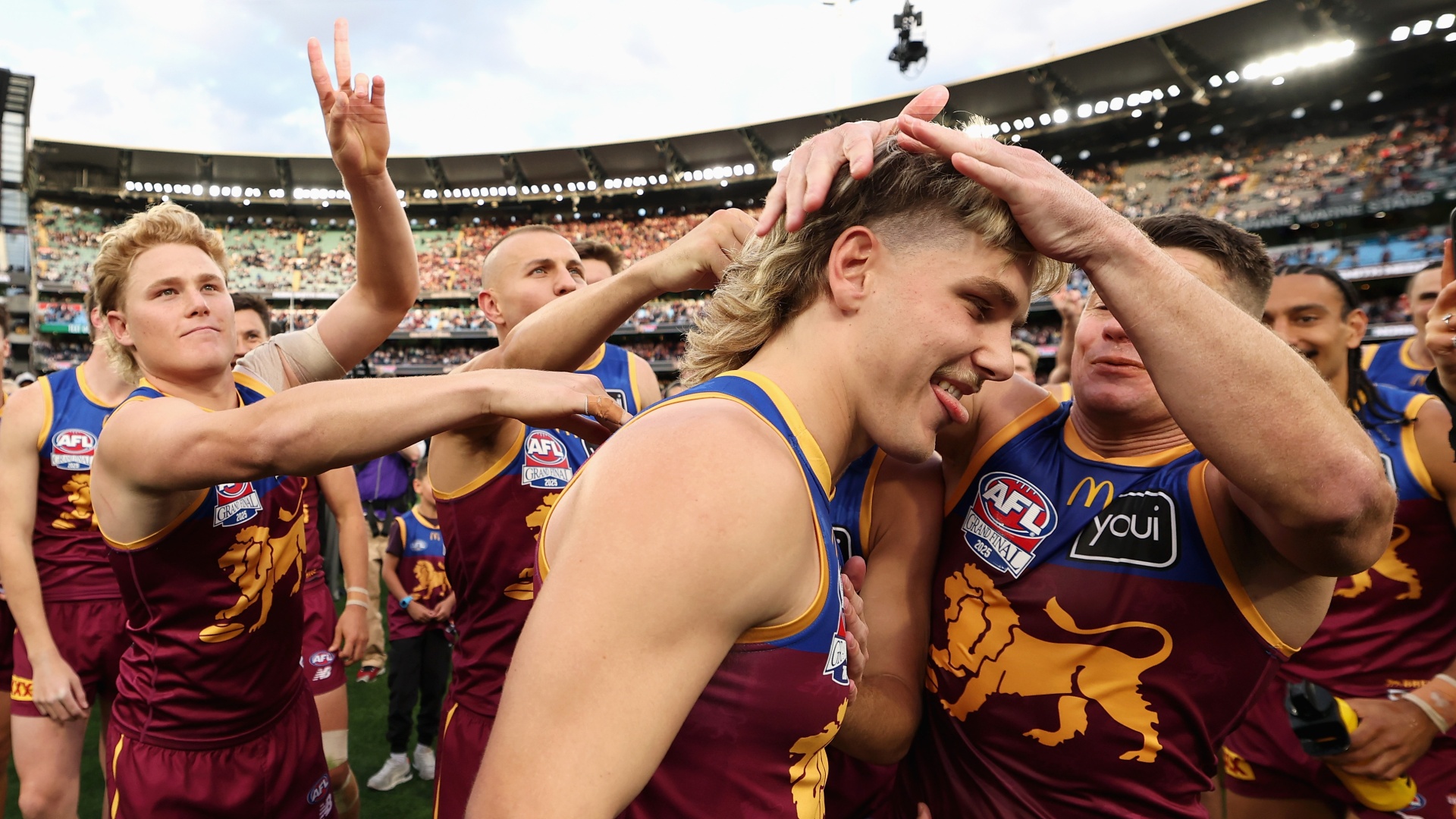 Will Ashcroft of the Brisbane Lions being congratulated by teammates after being named the Norm Smith medalist during the AFL Grand Final in September 2025