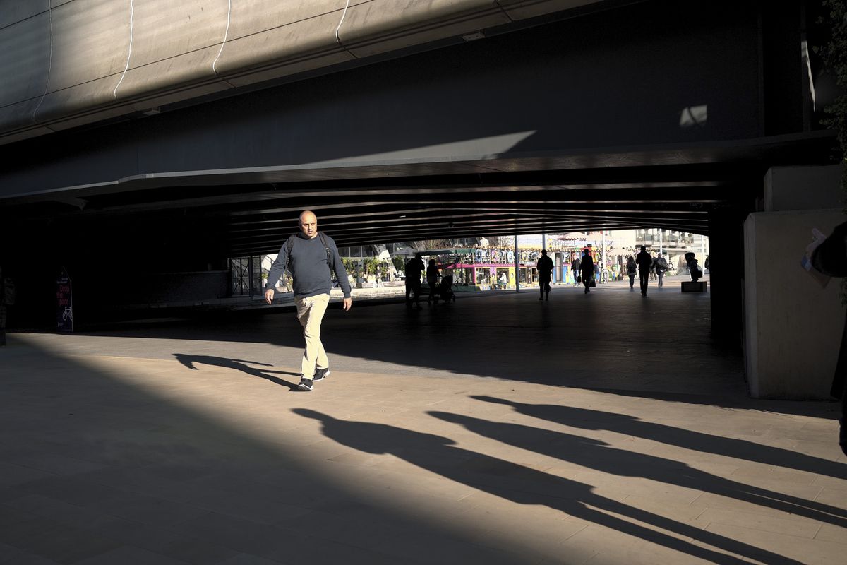 London street photo of people walking in bright sunlight with strong shadows cast on the ground, taken with the Sigma BF camera and Sigma 35mm F2 DG lens